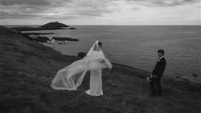 Bride with veil on coastal cliffs
