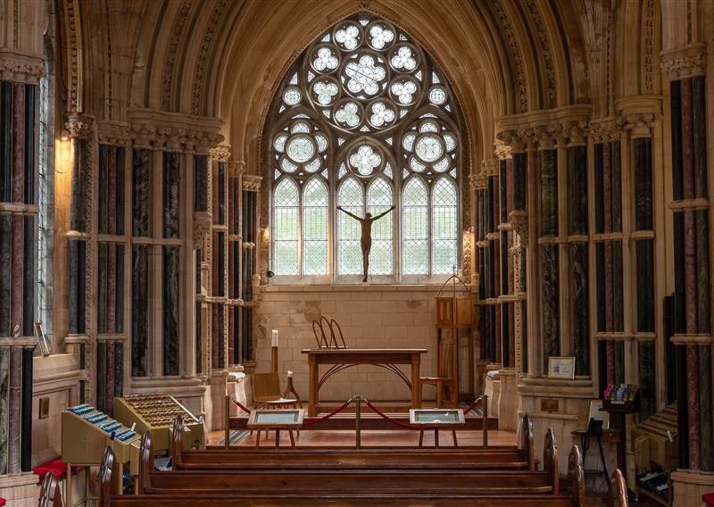 image of the inside of a gothic church showing the altar and windows