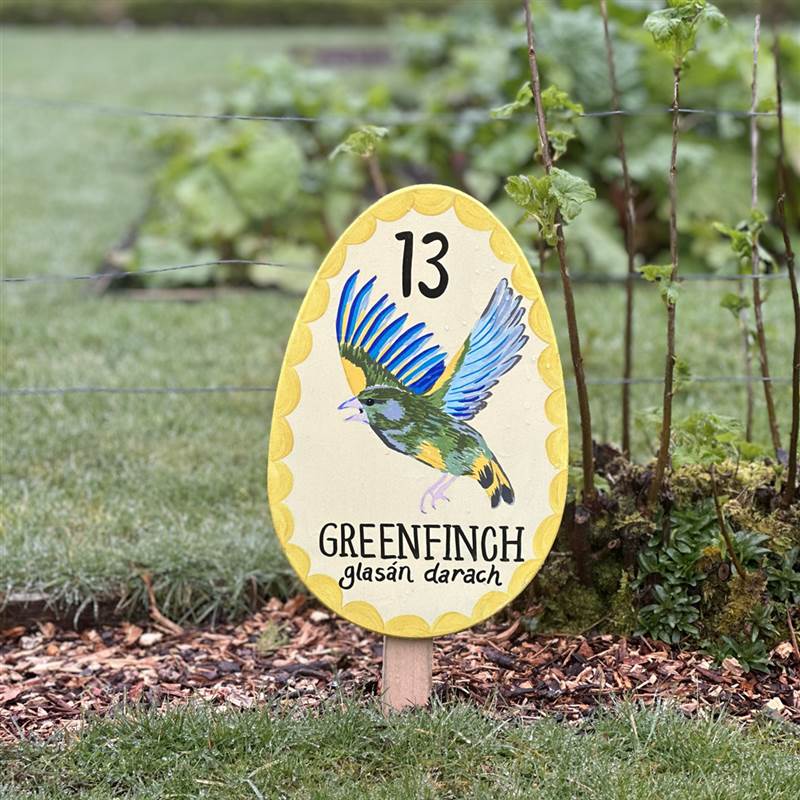 Image of an egg shaped signpost with an image of a greenfinch bird and the number 13 on it.