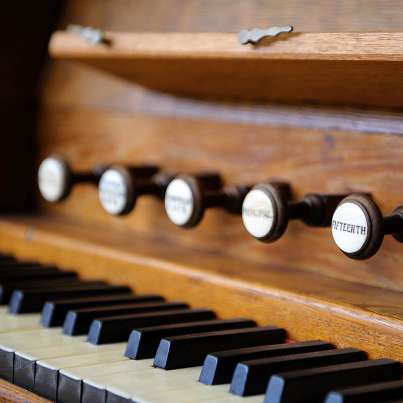 wooden organ with buttons and keys