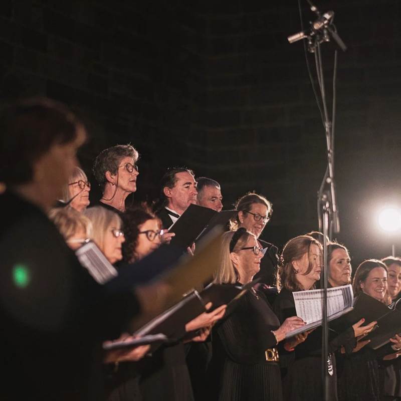 choir singing in a dark room with lights